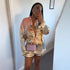 Person wearing a colorful outfit with a matching bag in a mirror selfie.